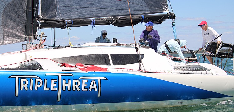 The team aboard the "Triple Threat," captained by John Novak, rounds the first marker of the Bird Key Yacht Club's annual Sarasota Bay Cup regatta on April 11.