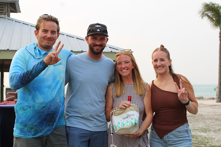 Anderson Brunsvold, Nick and Jane Lovisa, and Audrey Gaskill celebrate winning second place in the PHRF Multihull category of the Sarasota Bay Cup regatta.