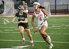 Midfielder/attacker Kaitlin Carolan (right) speeds past a Saint Stephen's Episcopal player during the FHSAA Class 1A-District 10 semifinals on April 10. She's one of three sophomores who lead the Cougars in scoring this season.