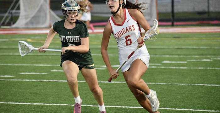 Midfielder/attacker Kaitlin Carolan (right) speeds past a Saint Stephen's Episcopal player during the FHSAA Class 1A-District 10 semifinals on April 10. She's one of three sophomores who lead the Cougars in scoring this season.