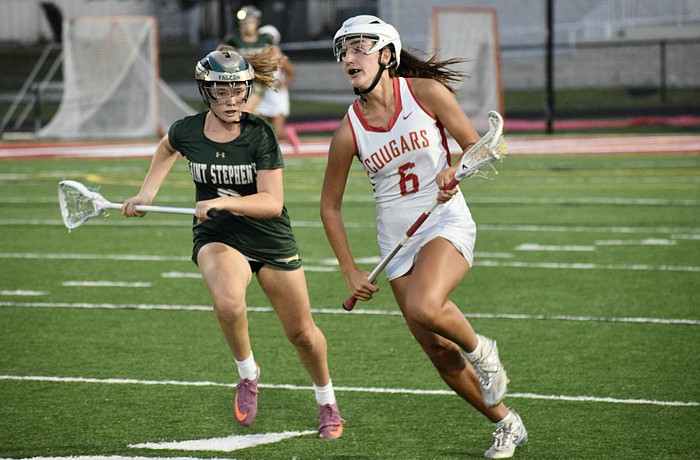 Midfielder/attacker Kaitlin Carolan (right) speeds past a Saint Stephen's Episcopal player during the FHSAA Class 1A-District 10 semifinals on April 10. She's one of three sophomores who lead the Cougars in scoring this season.
