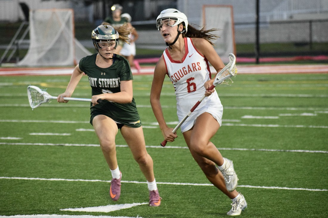 Midfielder/attacker Kaitlin Carolan (right) speeds past a Saint Stephen's Episcopal player during the FHSAA Class 1A-District 10 semifinals on April 10. She's one of three sophomores who lead the Cougars in scoring this season.