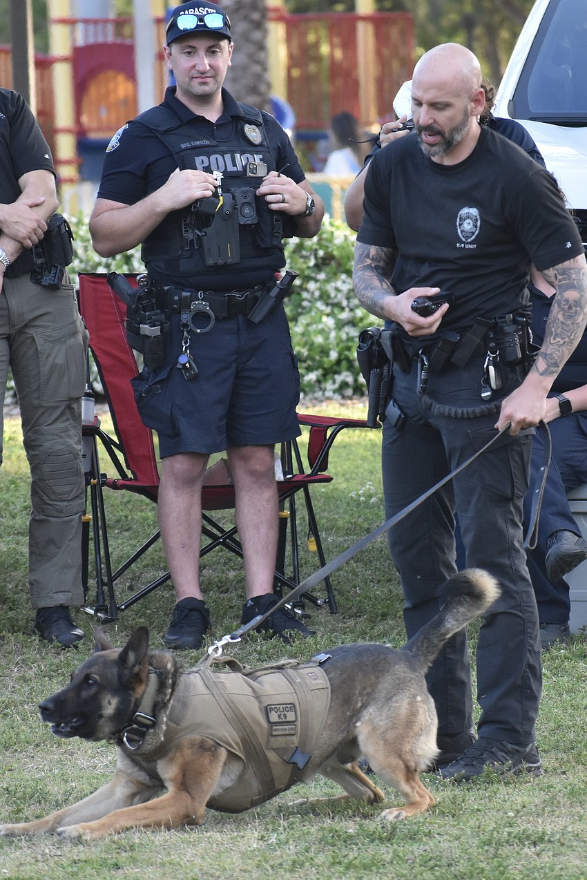 Staff including Officer Andrew Capozzi watch as Brody gets target, led by his handler, Officer Jacob Nelson.