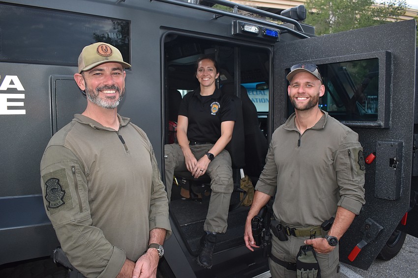 Officers Matt Hughes, Jenna Harper and Aaron Modrow showcase the SWAT vehicle.