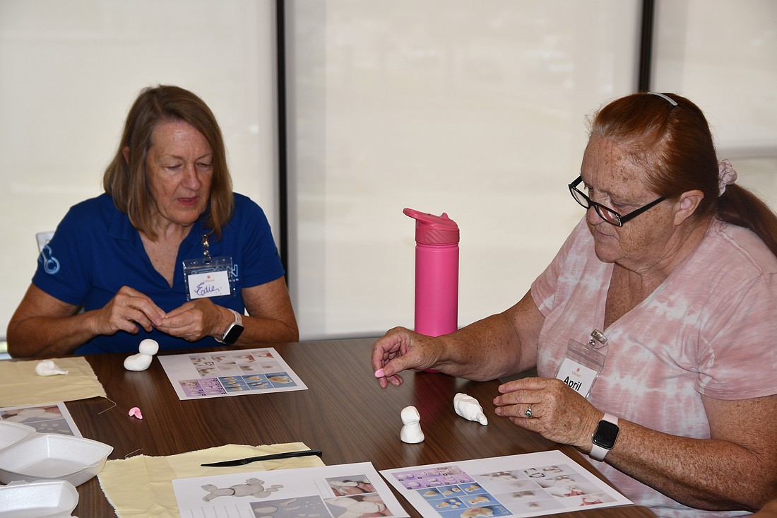 Vibrant members focused as they created a clay bunny.