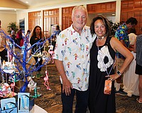Le Gardenia Bleu's John and Lita Brannan showcase their ornament tree filled with Florida's iconic flamingos and more at the 20th annual Meet Greet Eat.