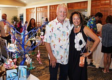 Le Gardenia Bleu's John and Lita Brannan showcase their ornament tree filled with Florida's iconic flamingos and more at the 20th annual Meet Greet Eat.
