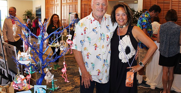 Le Gardenia Bleu's John and Lita Brannan showcase their ornament tree filled with Florida's iconic flamingos and more at the 20th annual Meet Greet Eat.