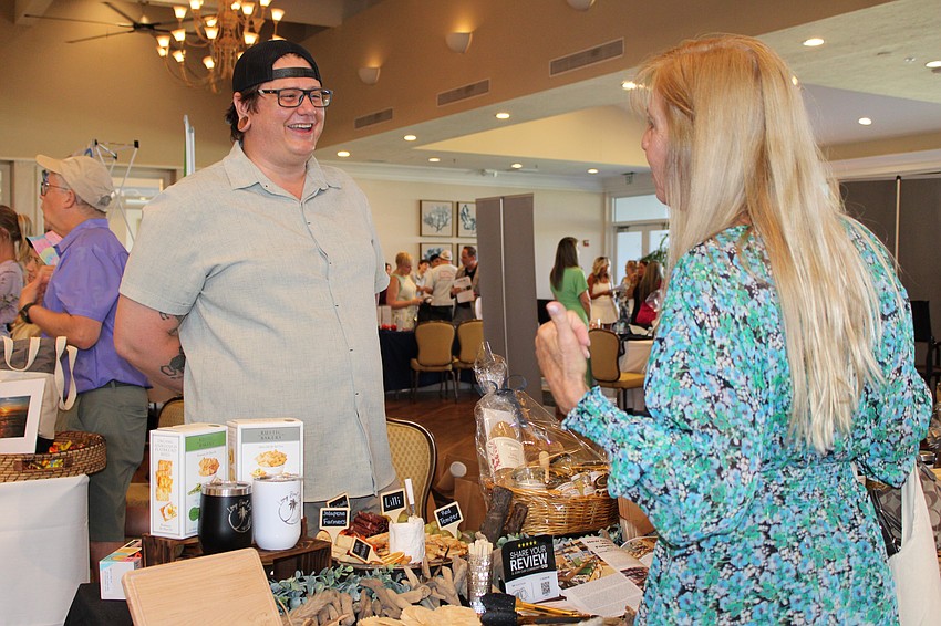 Jason Bond, owner of the newly opened Longboat Key Provisions, chats with a visitor at the 20th annual Meet Greet Eat hosted by the Longboat Key Chamber of Commerce.