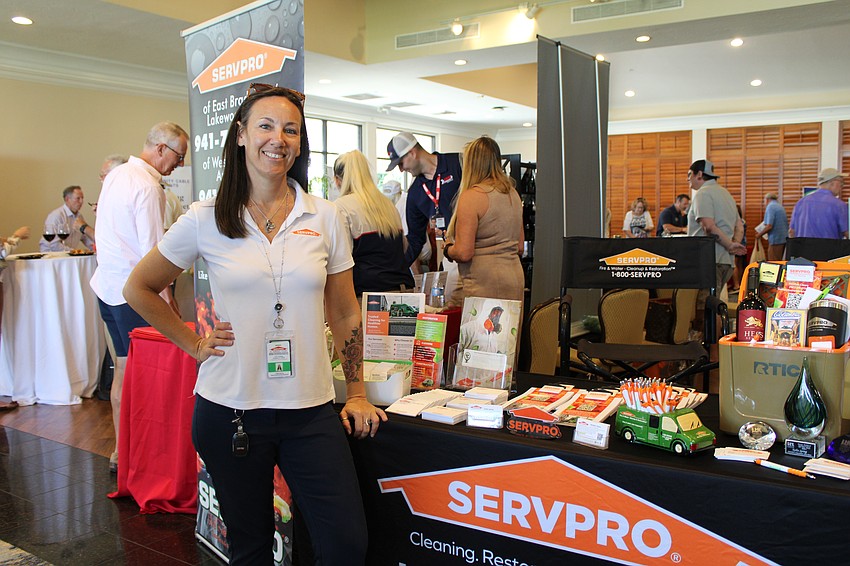 Kellie Spring from Servpro gives visitors at the Meet Greet Eat networking event advice on preparing for hurricane season.