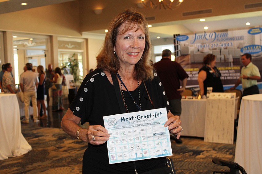 Holly Barrett shows the progress she made so far in getting her passport stamped at the Longboat Key Chamber of Commerce's Meet Greet Eat event, where local organizations connected with residents.