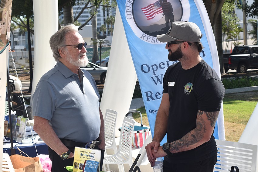 Harry Lapping, a veteran who was a Navy SEAL in Vietnam and was visiting from Maryland, speaks with Navy veteran Hunter DeSenti of Operation Warrior Resolution.