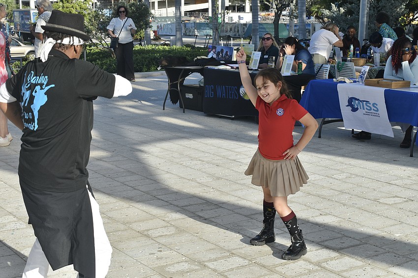 Donald Frison, resident choreographer of Westcoast Black Theatre Troupe, dances with Piper Borgia-Howard, 7.