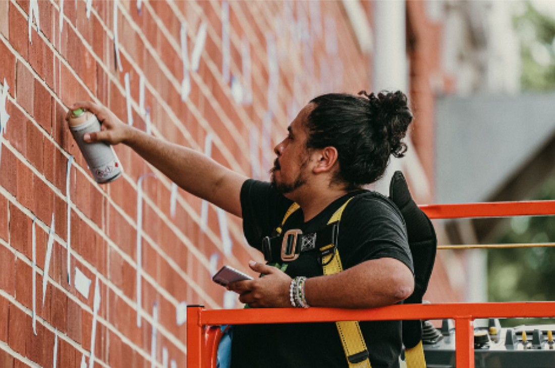 Jacksonville artist Martin Torres paints a mural.