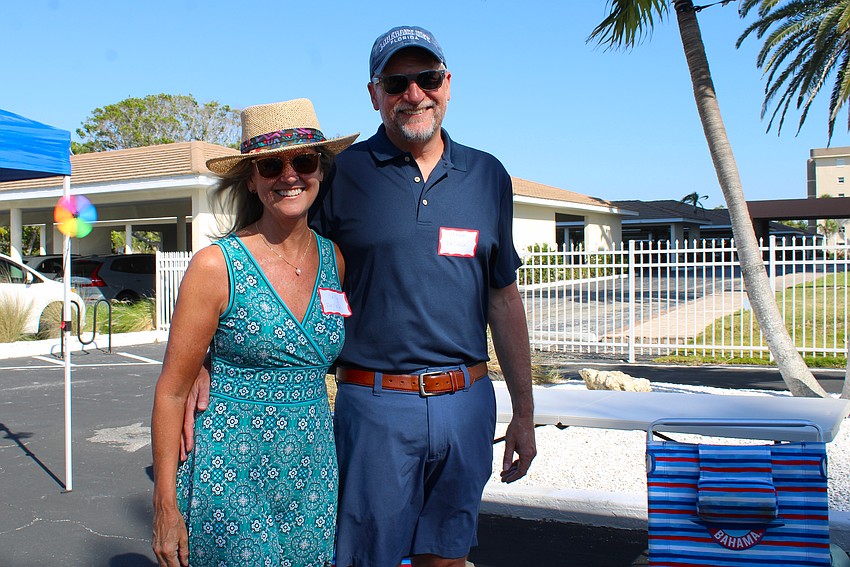Sally and Steve Delisle join in the tropical fun for Longboat Harbour's annual beachside pizza party.