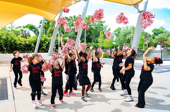 Girls celebrate Girls Inc. outside feeling victorious after their welcome song.