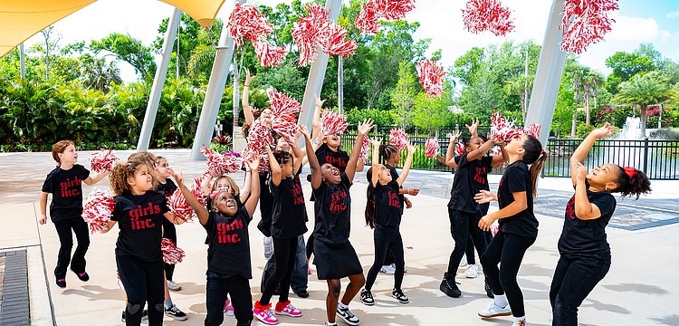 Girls celebrate Girls Inc. outside feeling victorious after their welcome song.