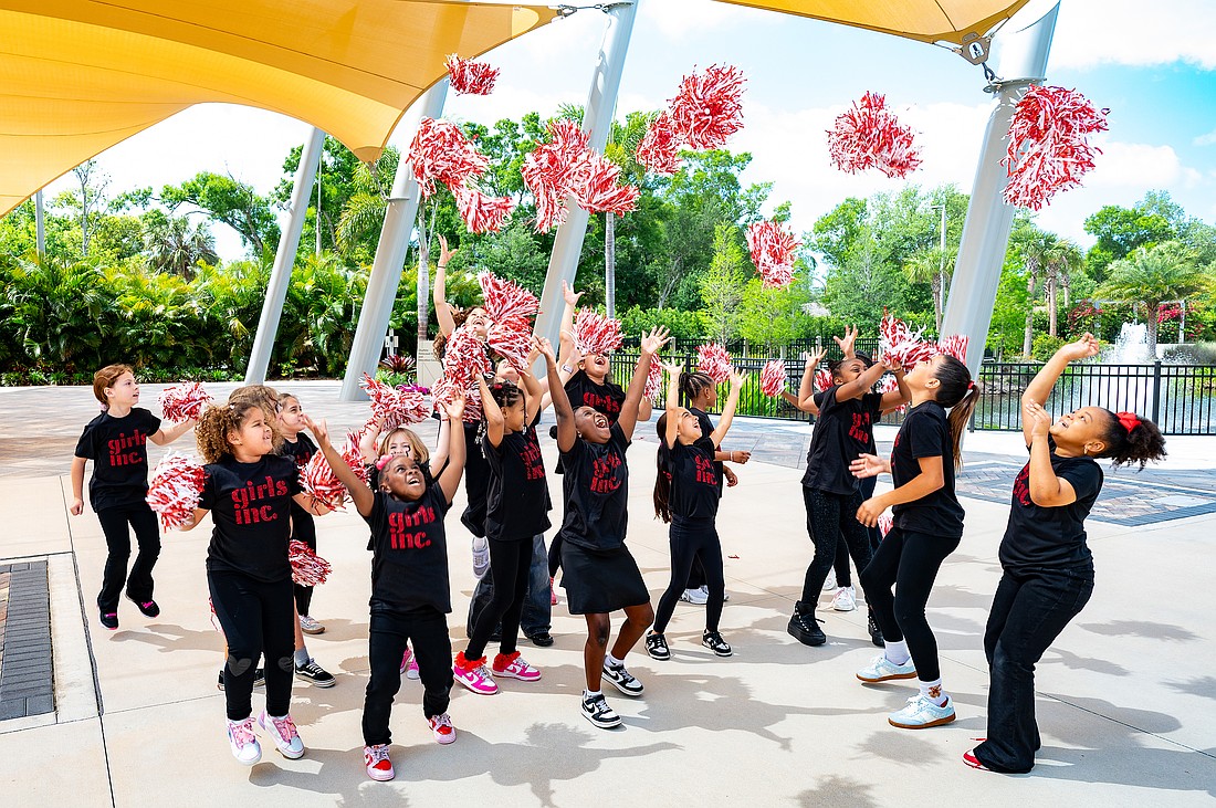 Girls celebrate Girls Inc. outside feeling victorious after their welcome song.