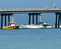 The sailboat Hula Girl is seen alongside the Longboat Pass bridge after colliding with the span on Friday, April 17.