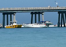 The sailboat Hula Girl is seen alongside the Longboat Pass bridge after colliding with the span on Friday, April 17.