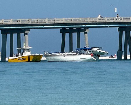 The sailboat Hula Girl is seen alongside the Longboat Pass bridge after colliding with the span on Friday, April 17.
