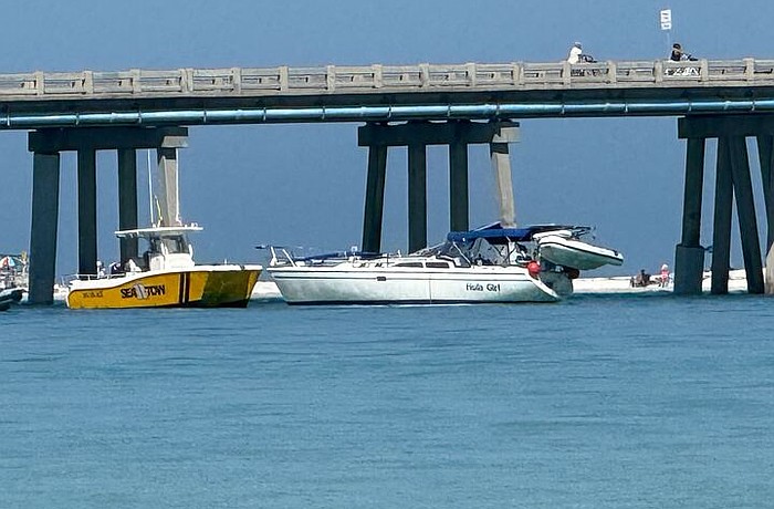 The sailboat Hula Girl is seen alongside the Longboat Pass bridge after colliding with the span on Friday, April 17.