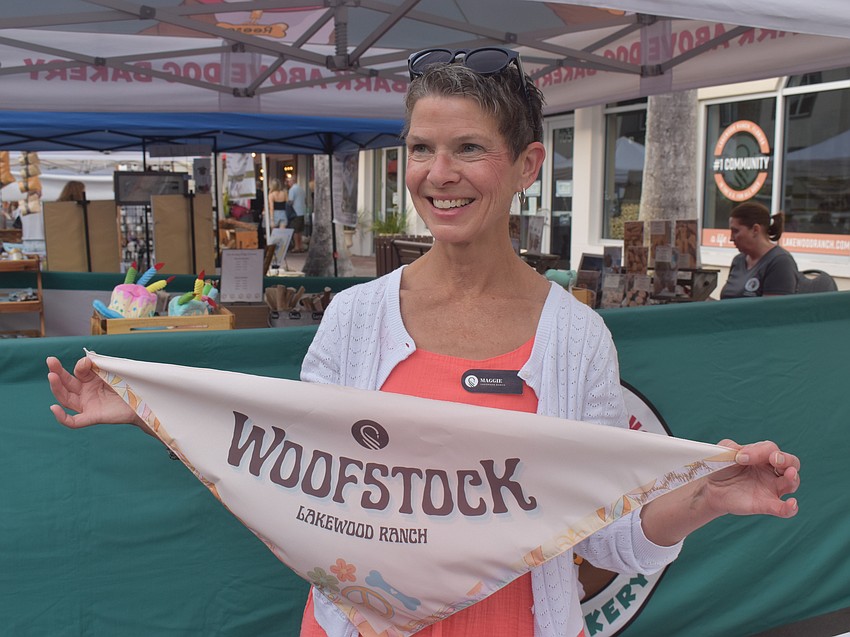 Maggie Milne, a community guide with the Lakewood Ranch New Homes Center, makes sure as many furry friends as possible receive a Woofstock bandana.