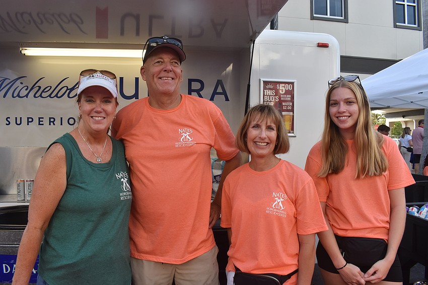 Tracy Bohlmann, Gary Heckman, Kolleen Urich and Allison Van Hatten work the drink booth as volunteers for Nate's Honor Animal Rescue Center, the beneficiary of Woofstock.
