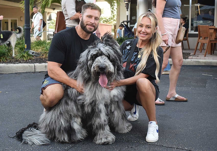 Waterside's Josh Mott and Krystal Hall attend Woofstock on Lakewood Main Street with 14-month-old Saint Berdoodle named River.