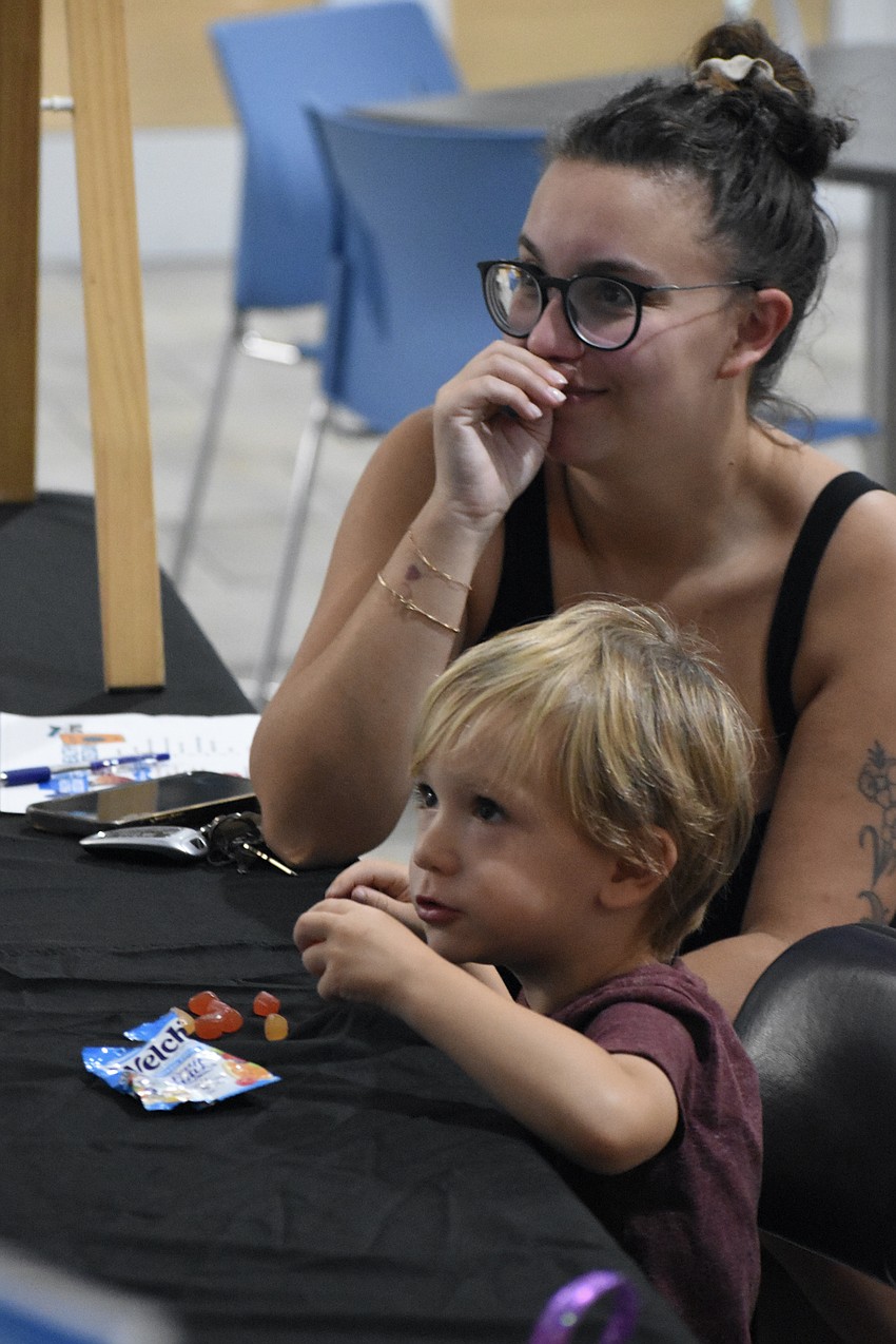 Giada Cavaterra and her son Nate Barfield, 3, participate in an activity by League of Women Voters featuring ranked choice voting for a set of treats.