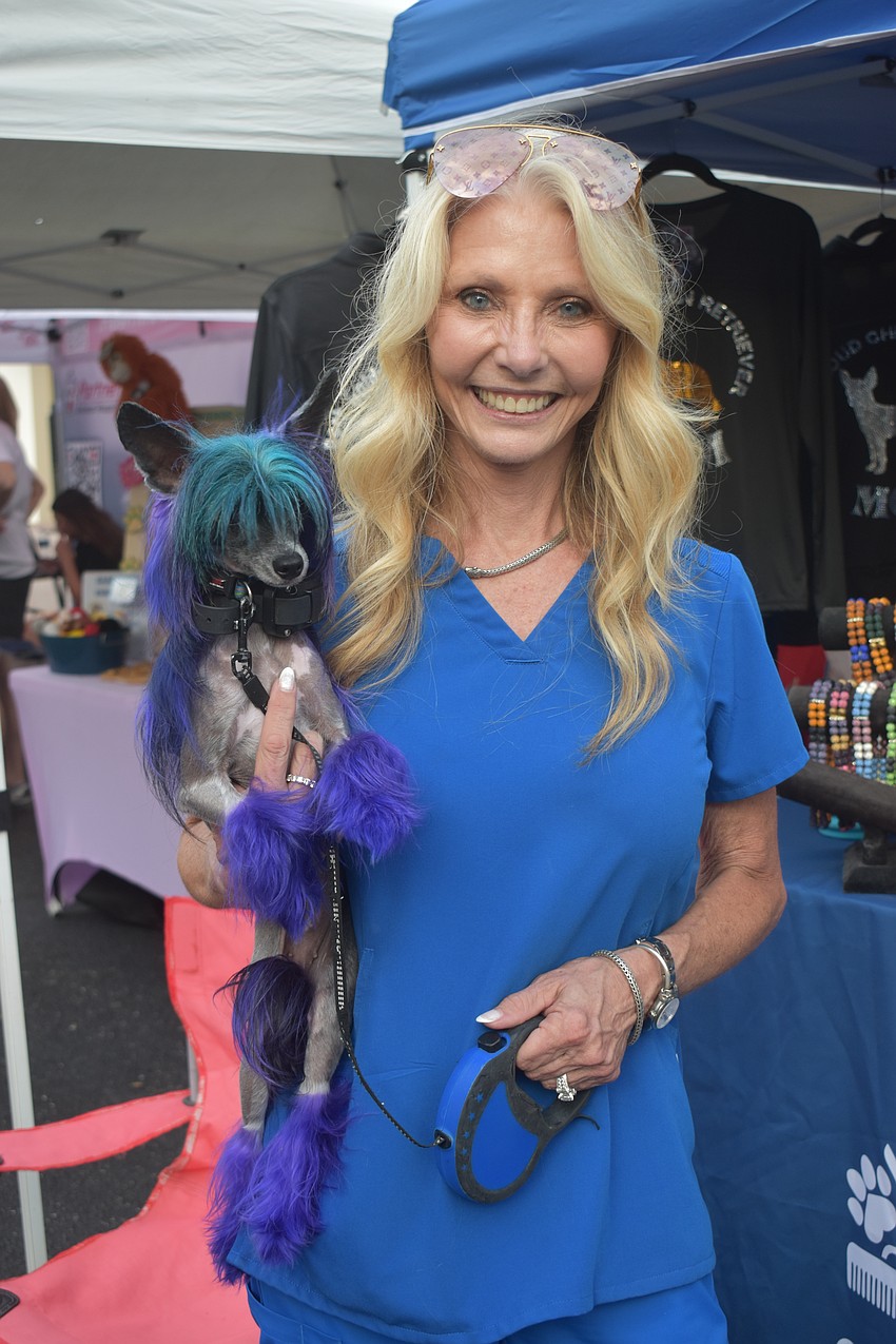 Renae Fjugstad, owner of Suds ‘n Scissors Pet Spa in Lakewood Ranch, attends Woofstock with her 3-year-old Chinese Crested Sailor.