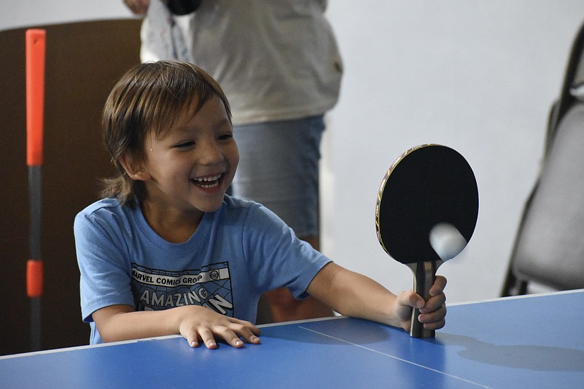 Mi-Seon Poma, 4, plays table tennis with an instructor from Palms Table Tennis.