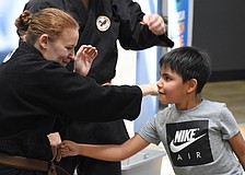 Elizabeth Hall of Cypress Pillar Healing Arts teaches Liam Lopez, 6.