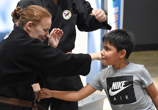 Elizabeth Hall of Cypress Pillar Healing Arts teaches Liam Lopez, 6.