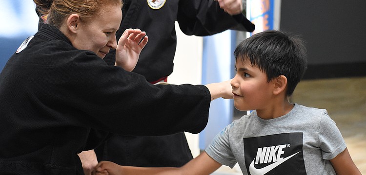 Elizabeth Hall of Cypress Pillar Healing Arts teaches Liam Lopez, 6.