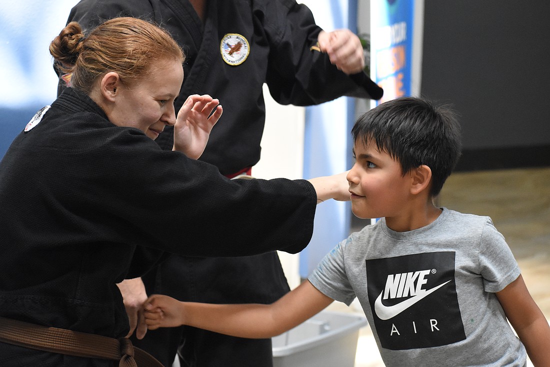 Elizabeth Hall of Cypress Pillar Healing Arts teaches Liam Lopez, 6.