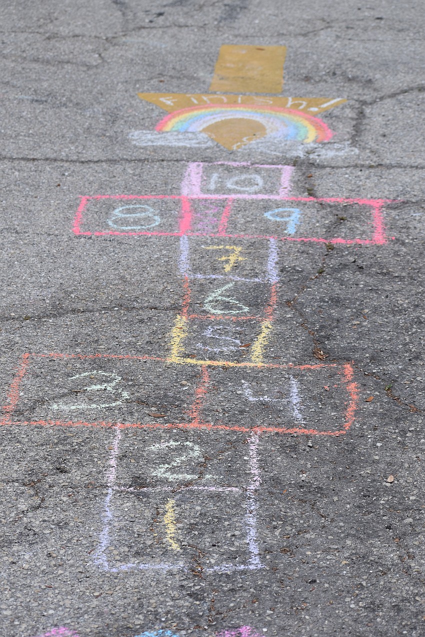 A game of hopscotch is drawn on the ground for kids.