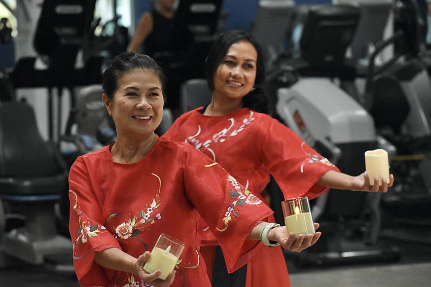 Maria Jennings and Genelyn Rorer perform perform the Philippine folk dance Pandanggo sa Ilaw (Dance of Lights).