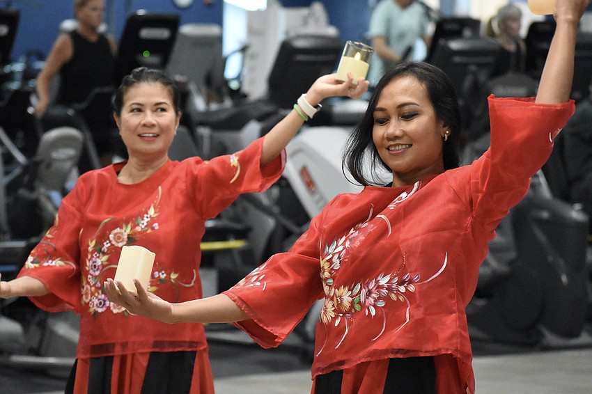 Maria Jennings and Genelyn Rorer perform perform the Philippine folk dance Pandanggo sa Ilaw (Dance of Lights).