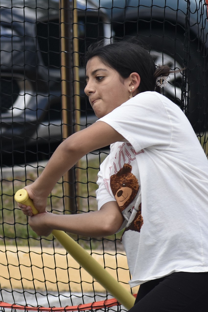Ava Alonso, 11, hits a ball with The Sports Farm.