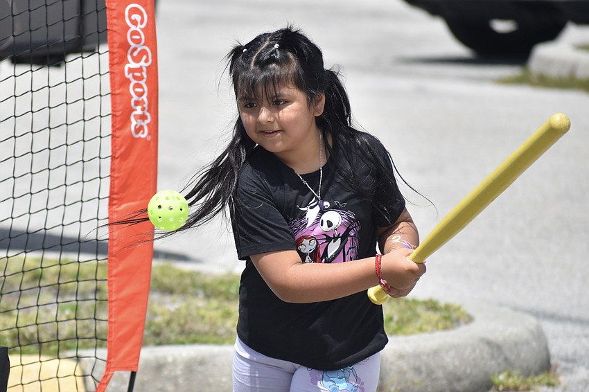 Khloe Sanchez, 7, practices baseball.