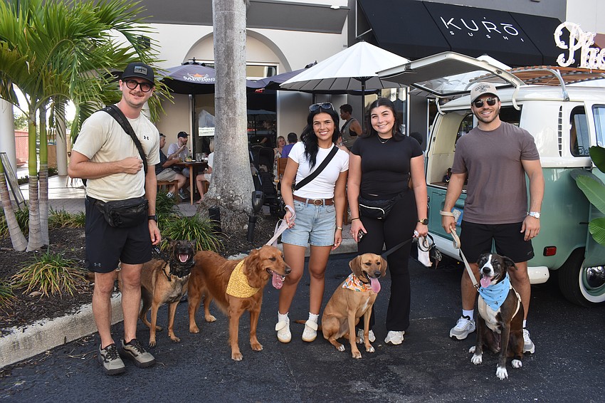 Sarasota's Andrew Vuleta, Amanda Moura, London Profita and Dante Profita walk Lakewood Main Street with their dogs Athena, Capri, Nala and Luna at Woofstock.