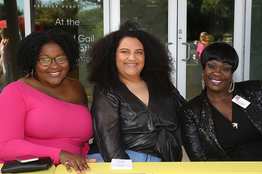 Ki Thomas, Regnia Belvin and Arnette German help register 323 guests.