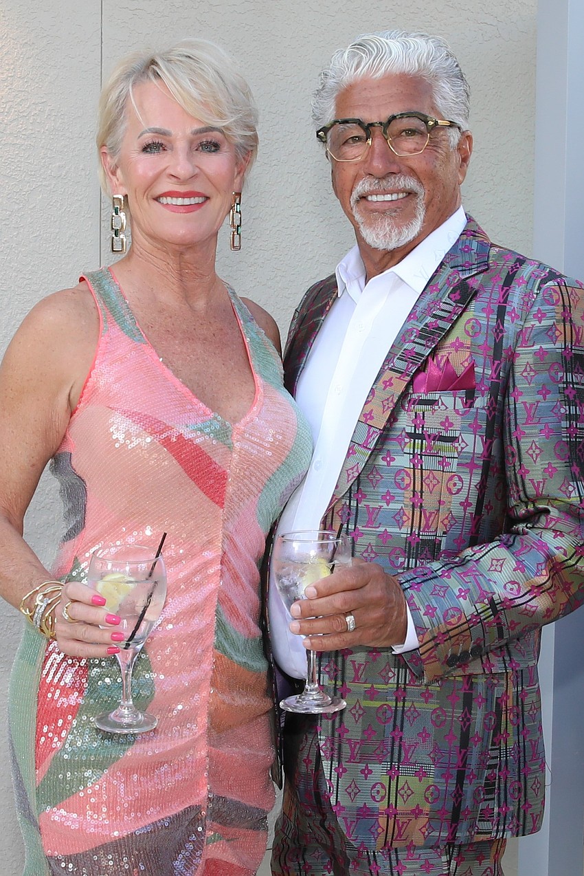 Charlotte Stewart and her husband, Carl Troiano, don matching fête attire.