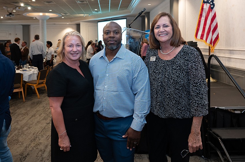 Kim Glogovsky, Brian Coleman,  assistant team leader of White Glove Service Goodwill Manasota receiving the Robert W. Rosinsky Achiever of the Year Award, and Donna Evans
