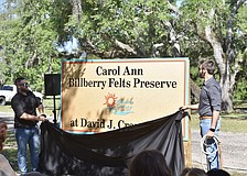 Carol Ann Felts' sons Kiel and Nicholas Felts unveil the new sign at David J. Crane Park.