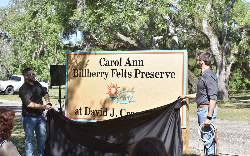 Carol Ann Felts' sons Kiel and Nicholas Felts unveil the new sign at David J. Crane Park.