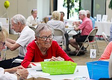 Volunteer Jane Webb joins approximately 40 other volunteers in packing jalapeño seeds on April 13 at Christ Church of Longboat Key. This was the final monthly meet-up of the season, and contributors celebrated their milestone of packing 500,000 seed packets this year.