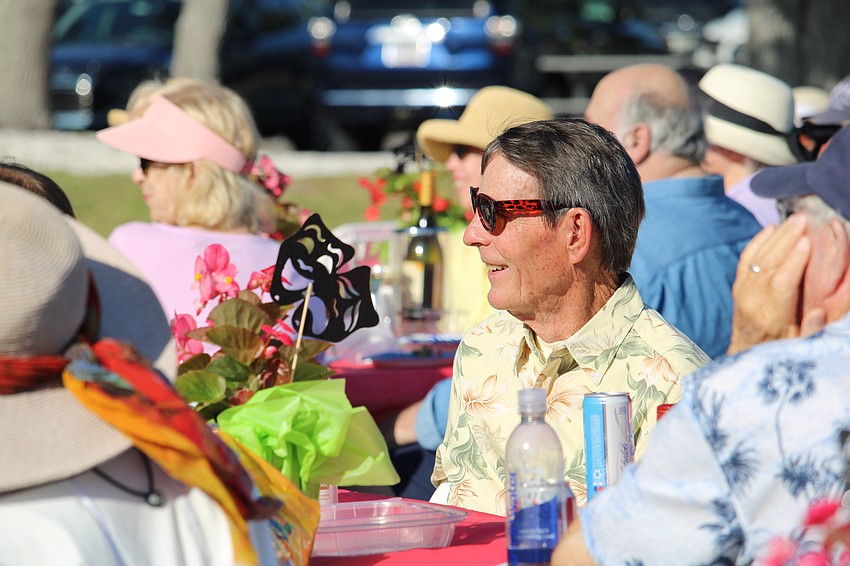 Comedy Night attendee Jim Larson cracks a smile during Al Ernst's opening set on April 16 at the Town Center Green.