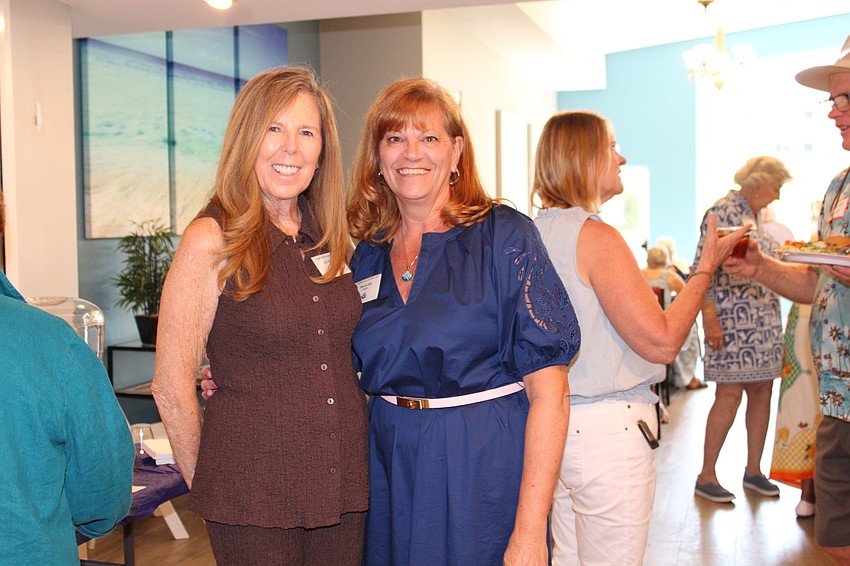 Lyn Haycock, one of the main coordinators of the Taste of the Keys fundraiser that plays a major role in the Longboat Key Garden Club's annual grant and scholarship awards, celebrates with President Melanie Dale at the end-of-season luncheon.
